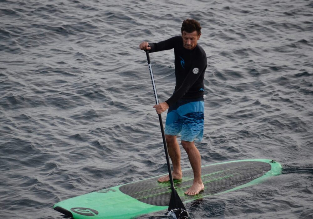 man-stand-up-paddle-boarding